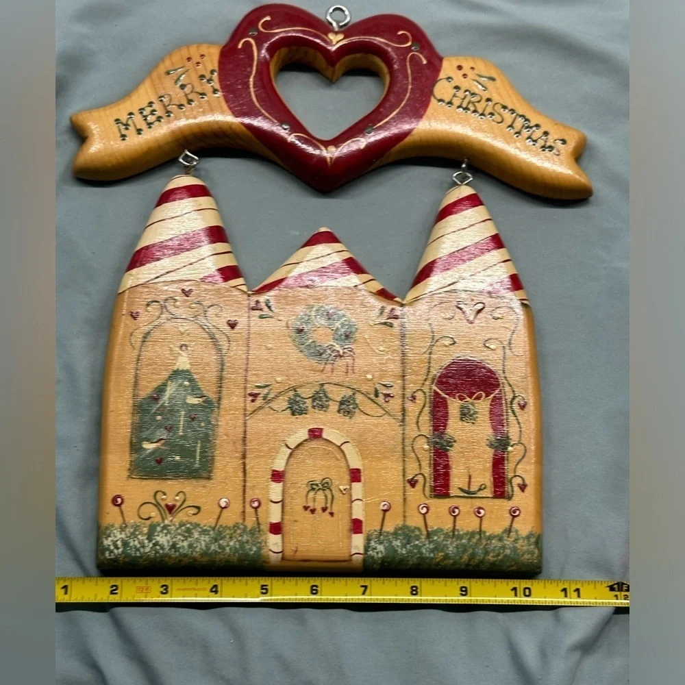 Unique wooden house with Merry Christmas sign handmade in Mexico.